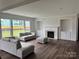 Bright living room features a fireplace, built-in shelves, and large windows offering lots of natural light at 4038 Gardenia Dr # 0114, Harrisburg, NC 28075