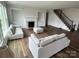 Open-concept living room features a fireplace, built-in shelves, and stairs with wrought iron railings at 4038 Gardenia Dr # 0114, Harrisburg, NC 28075