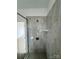 Tiled shower with glass door in a modern bathroom at 4038 Gardenia Dr # 0114, Harrisburg, NC 28075
