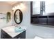 Bathroom featuring a modern vanity with marble countertop and ample lighting at 405 W 7Th St # 408, Charlotte, NC 28202