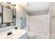 This bright bathroom features a tub and shower combination and a decorative mirror at 405 W 7Th St # 408, Charlotte, NC 28202