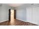 This bedroom features wood floors, neutral gray walls, a closet and doorway to the kitchen at 405 W 7Th St # 408, Charlotte, NC 28202