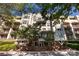 Apartment building with mature trees, balconies, and brick accents at 405 W 7Th St # 408, Charlotte, NC 28202