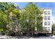 Apartment complex with lush green trees and brick accents on a sunny day at 405 W 7Th St # 408, Charlotte, NC 28202