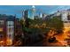 Scenic evening view of the Charlotte skyline from a residential area, highlighting city lights and greenery at 405 W 7Th St # 408, Charlotte, NC 28202