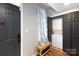 Inviting entryway with laundry closet, bench, hardwood floors, and painted doors at 405 W 7Th St # 408, Charlotte, NC 28202