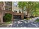 Exterior of a garage building with mature trees offering plenty of shade at 405 W 7Th St # 408, Charlotte, NC 28202