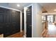 Hallway with dark closet doors, coat hooks, and hardwood floors that lead to the living areas at 405 W 7Th St # 408, Charlotte, NC 28202