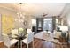 Bright living room featuring hardwood floors, fireplace, and a modern chandelier at 405 W 7Th St # 408, Charlotte, NC 28202