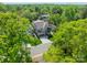 An aerial view of a luxurious home surrounded by lush greenery and mature trees in a serene neighborhood at 410 Mcalway Rd, Charlotte, NC 28211