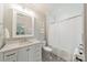A bright bathroom features white cabinets, updated fixtures, and a shower with white tile at 410 Mcalway Rd, Charlotte, NC 28211