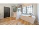 Bright bathroom featuring a standalone tub and a large shower with glass doors and a neutral color palette at 410 Mcalway Rd, Charlotte, NC 28211