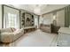 Charming Bedroom with a soft color palette, built-in shelving, and elegant light fixture in a cozy space at 410 Mcalway Rd, Charlotte, NC 28211