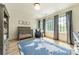 Bedroom features hardwood floors, large windows, a crib, and a blue and white map rug at 410 Mcalway Rd, Charlotte, NC 28211