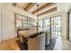 Elegant dining room featuring a large wooden table, comfortable seating, exposed beams, and expansive windows at 410 Mcalway Rd, Charlotte, NC 28211