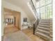 Inviting foyer with hardwood floors, staircase with large windows, and stylish decor at 410 Mcalway Rd, Charlotte, NC 28211