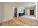 Open hallway with hardwood floors, dark accent doors, and a neutral color scheme in an elegant home at 410 Mcalway Rd, Charlotte, NC 28211