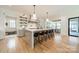 Spacious kitchen featuring a large island with seating, open shelving, and modern appliances at 410 Mcalway Rd, Charlotte, NC 28211