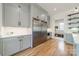 Spacious kitchen featuring stainless steel refrigerator, custom cabinets, and an adjacent area with built-in storage at 410 Mcalway Rd, Charlotte, NC 28211