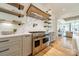 Gourmet kitchen features stainless steel appliances, a pot filler, custom cabinets, and beautiful marble countertops at 410 Mcalway Rd, Charlotte, NC 28211