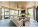 Relaxing screened-in porch features a cozy seating area, fireplace, and a ceiling fan for warm weather comfort at 410 Mcalway Rd, Charlotte, NC 28211