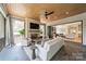 Cozy sunroom with a fireplace, comfortable seating, and seamless indoor-outdoor living at 410 Mcalway Rd, Charlotte, NC 28211