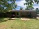 Relaxing backyard featuring a patio, lush lawn, mature trees, and a well-maintained exterior, perfect for outdoor living at 4230 Old Brittain Rd, Hickory, NC 28602