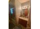 Compact bathroom featuring a shower/tub combo, vanity with storage, and neutral tile work, offering functionality at 4230 Old Brittain Rd, Hickory, NC 28602