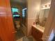 Compact bathroom featuring a shower/tub combo, vanity with storage, and neutral tile work, offering functionality at 4230 Old Brittain Rd, Hickory, NC 28602