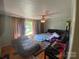 Spacious bedroom with hardwood floors, a ceiling fan, and ample natural light, offering a comfortable and inviting space at 4230 Old Brittain Rd, Hickory, NC 28602
