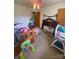 Smaller bedroom with ceiling fan and window, staged with furniture and decorations at 4230 Old Brittain Rd, Hickory, NC 28602