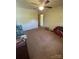 Standard bedroom with neutral carpet, ceiling fan, and a large window at 4230 Old Brittain Rd, Hickory, NC 28602