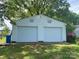 Two-car detached garage featuring two standard overhead doors and vinyl siding at 4230 Old Brittain Rd, Hickory, NC 28602