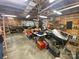 Large, cluttered garage with open wooden ceiling, tool benches, shelves, and various equipment at 4230 Old Brittain Rd, Hickory, NC 28602