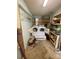 Laundry room features washer, dryer, wire rack shelving, and tile flooring at 4230 Old Brittain Rd, Hickory, NC 28602