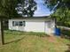 Exterior view of a single-story shed featuring vinyl siding, a window and one entry door at 4230 Old Brittain Rd, Hickory, NC 28602