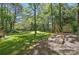 Landscaped backyard offering a large grassy area, a shed and a wooden swing set at 505 Southland Rd, Huntersville, NC 28078