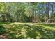 Expansive backyard showcasing well-maintained lawn, mature trees, and a storage shed at 505 Southland Rd, Huntersville, NC 28078