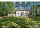 Back of house displaying a large deck and spacious backyard filled with mature trees at 505 Southland Rd, Huntersville, NC 28078