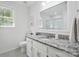 Elegant bathroom with granite countertops, white cabinetry, and modern fixtures offers a luxurious feel at 505 Southland Rd, Huntersville, NC 28078