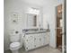 Well-lit bathroom with white vanity, granite countertop, and neutral decor provides a clean and inviting space at 505 Southland Rd, Huntersville, NC 28078