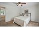 Bedroom with carpet flooring, ceiling fan, bedside table, and view to outdoors at 505 Southland Rd, Huntersville, NC 28078