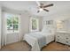 Comfortable bedroom with a cozy bed, ceiling fan, and bright natural light streaming in at 505 Southland Rd, Huntersville, NC 28078