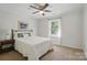 Bedroom featuring carpet, a ceiling fan, bedside table, and natural light from the window at 505 Southland Rd, Huntersville, NC 28078
