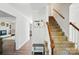 Inviting entryway with hardwood floors, staircase, bench seating, and decorative wall accents creates a warm welcome at 505 Southland Rd, Huntersville, NC 28078