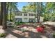 Charming two-story home featuring a white exterior, black shutters, and a beautifully landscaped front yard at 505 Southland Rd, Huntersville, NC 28078