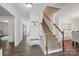 Open foyer showcasing hardwood floors, staircase with wooden railing, and ample natural light at 505 Southland Rd, Huntersville, NC 28078