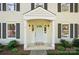 Welcoming front entrance with a covered porch, stylish lighting, and attractive landscaping enhances curb appeal at 505 Southland Rd, Huntersville, NC 28078