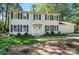 Classic two-story home featuring a well-maintained lawn, dark shutters and a covered front entry at 505 Southland Rd, Huntersville, NC 28078