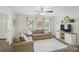 Bright living room with hardwood floors, neutral decor, and a ceiling fan for added comfort and style at 505 Southland Rd, Huntersville, NC 28078